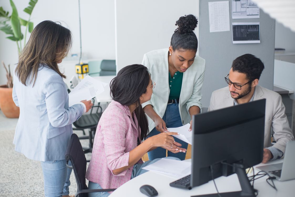 A diverse leadership team discussing AI readiness in a modern office